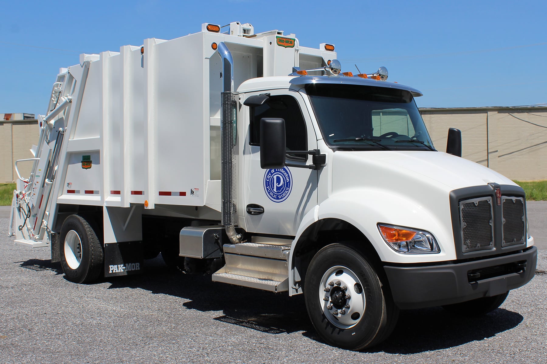 A new white City of Princeton garbage collection truck with City of Princeton Public Works insignia on the door.